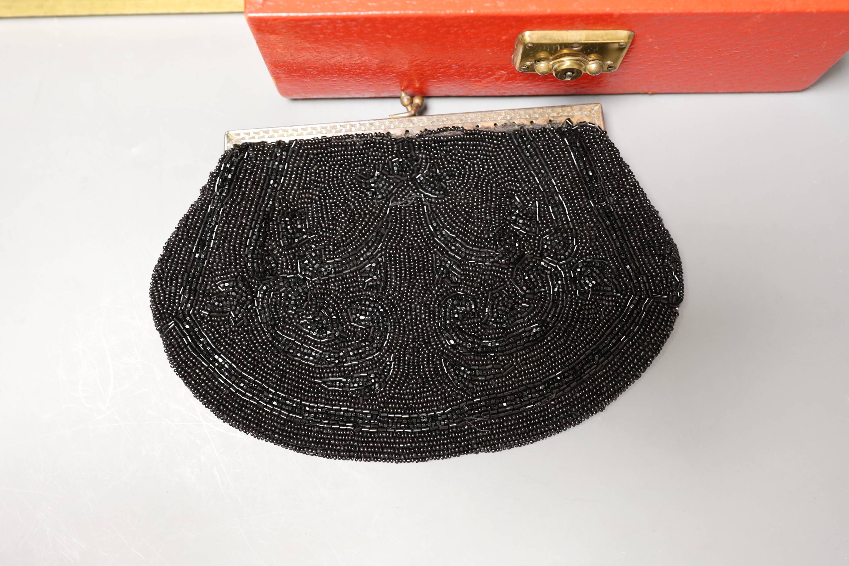 A 19th century cut steel, black velvet bag, a 1940’s-50’s diamanté handled clutch bag, 1930’s embroidered clutch bag, together with four later black beaded evening bags